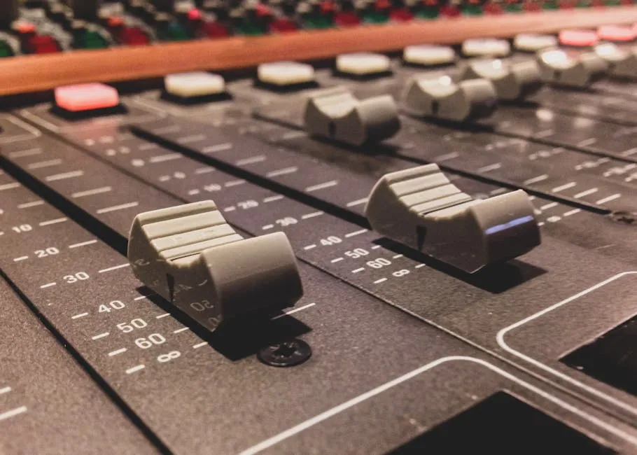 Close-up of studio mixing console faders and dials